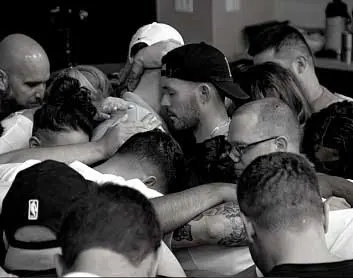 Ryan Zofay forming a circle and hugging friends.