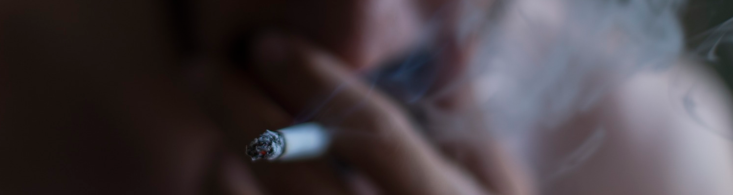 A man is contemplating the idea of going through a marijuana detox NJ while smoking.