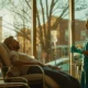 nurse in teal scrubs providing IV hydration therapy to a patient undergoing alcohol detox, in a clinic setting with soft morning light
