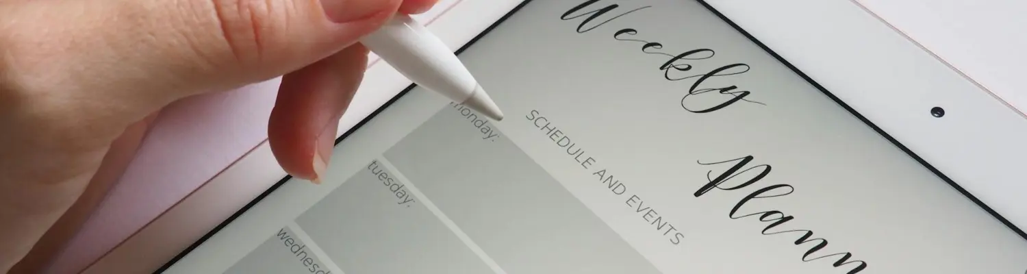 a woman writing in a planner 