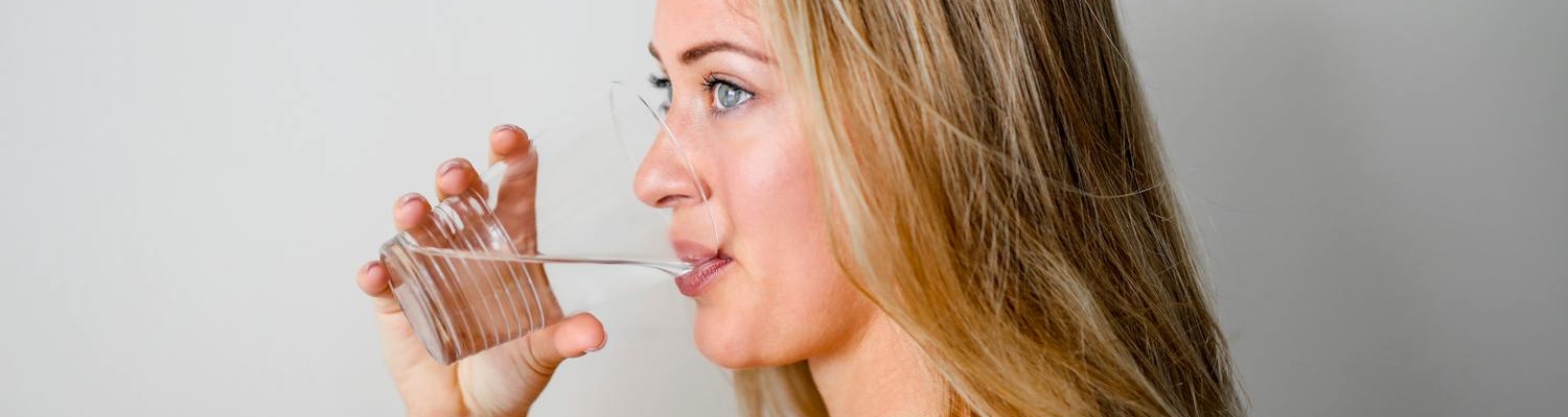 A person drinking water during alcohol detox programs nj