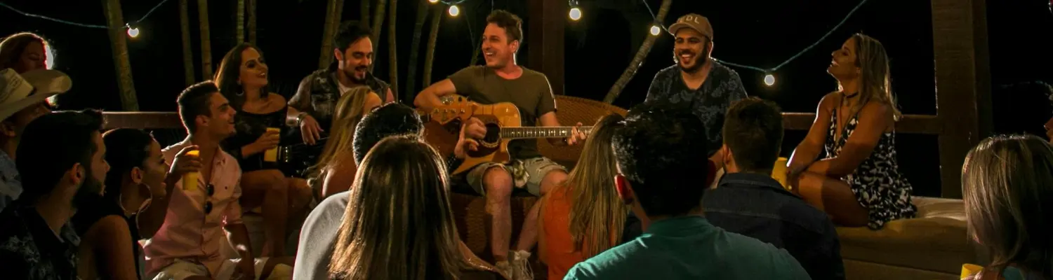 people singing to a man playing a guitar 