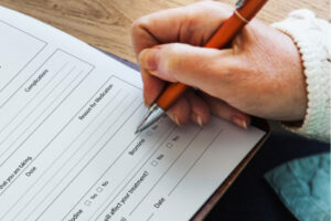 BCBS Insurance Coverage New Jersey featured image with a person filling out medical forms