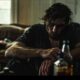 lonely man with alcohol addiction sitting on a worn-out couch